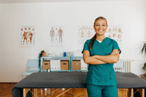 Confident female healthcare professional in scrubs standing in a medical office.